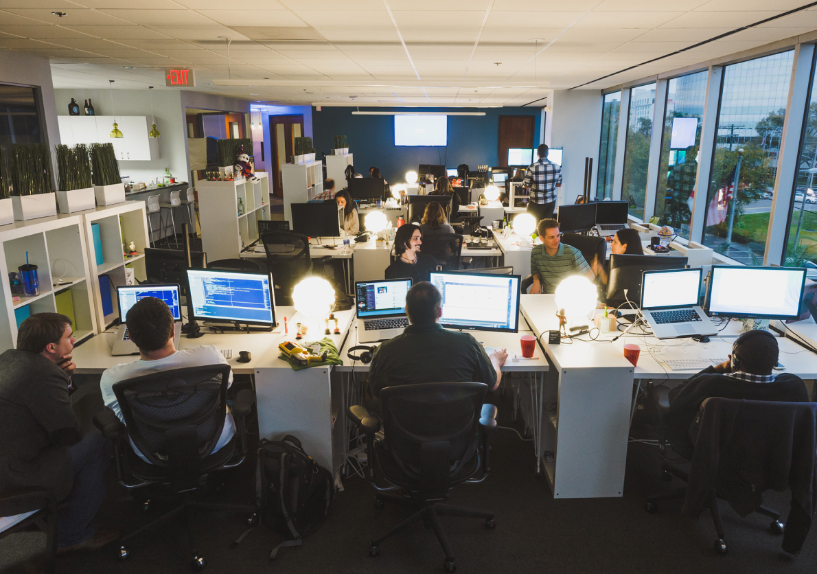 352 employees working on computers together in an office environment